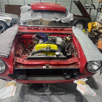 Fiat Spider in the bay, hood up